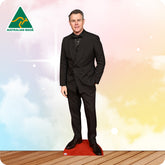 Cardboard cutout of a man in a black suit with 'Australian Made' logo on a colorful background